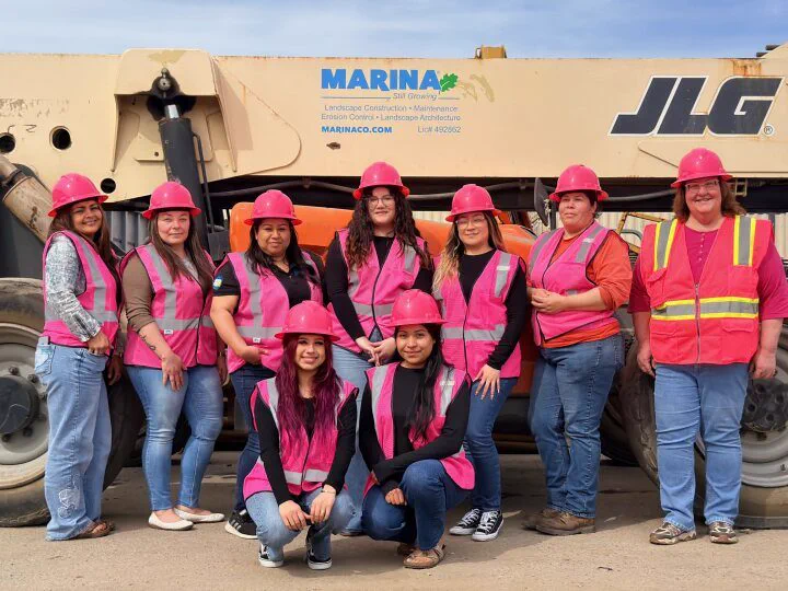 Marina crew in pink hard hats and high-visibility vests